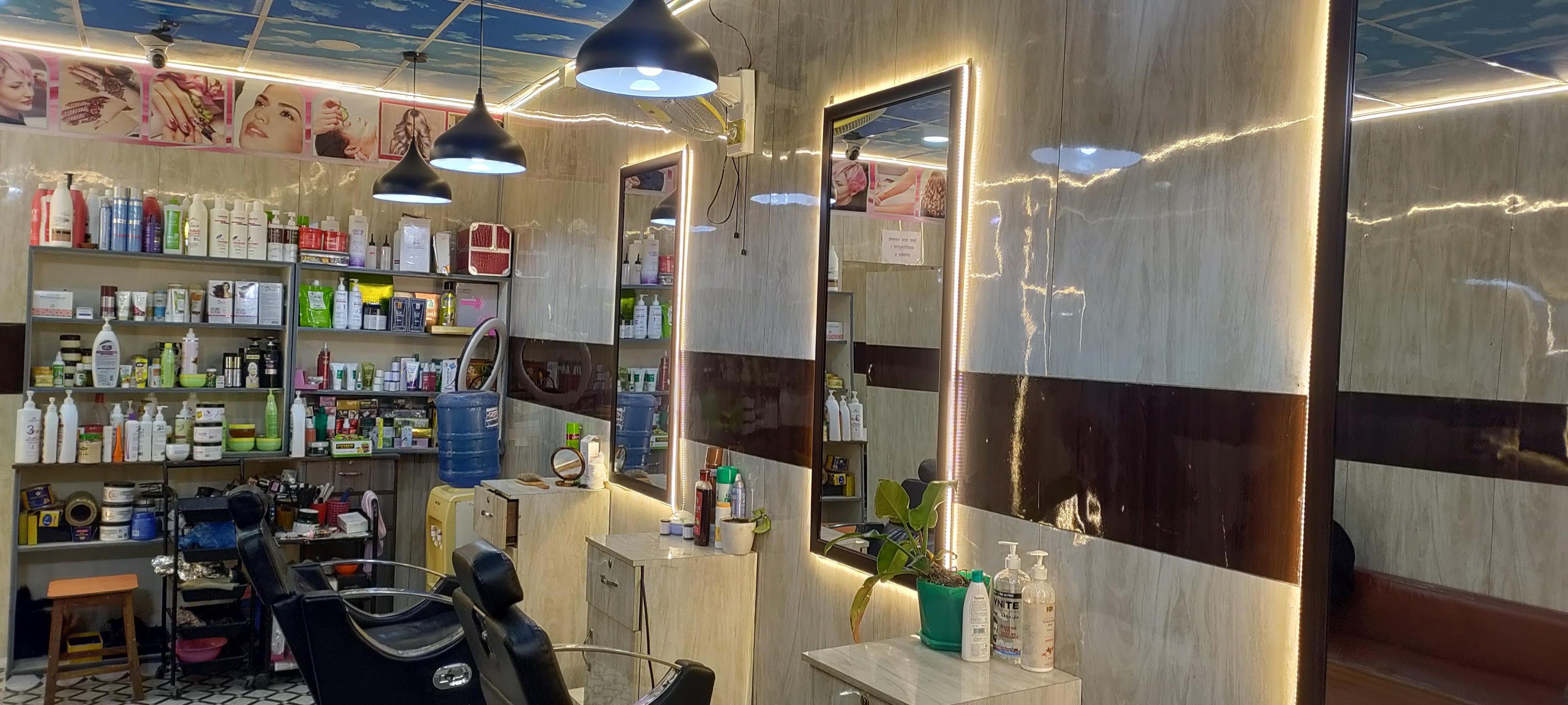 Marble-walled styling stations with warm tungsten pendant lights at Dragon Hair Salon
